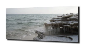 obraz na szkle Sople lodu na plaży zimą